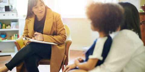 Support, talking and a therapist with a child and parent for discussion about education. Help, therapy and therapist speaking to a kid and mom about helping with mental health and learning disability