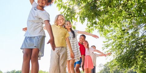 Children balancing in the summer in the park